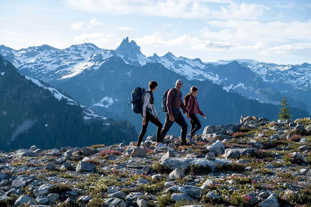 Group of hikers walking on a mountain trail during a day hike